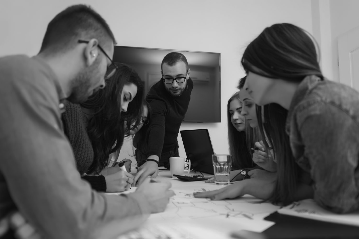 The BSCL team collaborating around a table in a working meeting